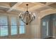 Bright living room with coffered ceiling, large windows, chandelier, and wainscoting at 4015 Sierra Vista Cir, Cumming, GA 30028