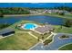 Aerial view of community pool with clubhouse, a lake, and many homes at 4015 Sierra Vista Cir, Cumming, GA 30028