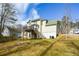 Back exterior view featuring a wooden deck with stairs to a lush green lawn at 581 Victorian Cir, Dallas, GA 30157