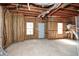 Unfinished basement showcases potential for customization, featuring exposed beams and natural light at 581 Victorian Cir, Dallas, GA 30157