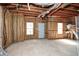 Unfinished basement with exposed insulation, with a door and two windows at 581 Victorian Cir, Dallas, GA 30157