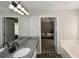Bathroom featuring a tub, walk-in shower, double vanity, and granite countertops at 581 Victorian Cir, Dallas, GA 30157