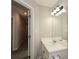 Bathroom featuring a single vanity with a light fixture and a carpeted hallway in view at 581 Victorian Cir, Dallas, GA 30157