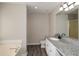 Bathroom featuring a granite countertops, vanity with double sinks and a tub at 581 Victorian Cir, Dallas, GA 30157