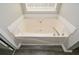 Bathroom showcasing a bright tub with light gray wooden floors at 581 Victorian Cir, Dallas, GA 30157