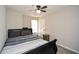 Bedroom featuring a dark wood bed frame, neutral walls and a ceiling fan at 581 Victorian Cir, Dallas, GA 30157