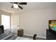 Bright bedroom with ceiling fan, tv on top of drawers, laundry basket and a comfy looking bed at 581 Victorian Cir, Dallas, GA 30157