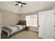 Cozy bedroom with a bed, nightstand, a ceiling fan and natural light from the window at 581 Victorian Cir, Dallas, GA 30157