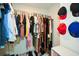 Walk-in closet featuring ample hanging space, shelves, and neat organization at 581 Victorian Cir, Dallas, GA 30157