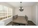 This dining room features a large table, wood floors, and a chandelier at 581 Victorian Cir, Dallas, GA 30157