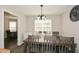 Formal dining room features modern chandelier and an oversized table at 581 Victorian Cir, Dallas, GA 30157