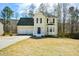 Charming two-story home with a two-car garage and a well-maintained front yard at 581 Victorian Cir, Dallas, GA 30157
