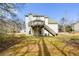 Rear exterior view of home, with a spacious deck, stairs and a well-maintained lawn at 581 Victorian Cir, Dallas, GA 30157