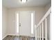 Bright foyer featuring a staircase with white railings and modern wood flooring at 581 Victorian Cir, Dallas, GA 30157