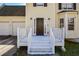 Close-up of the inviting front porch with white railings and a dark-colored front door at 581 Victorian Cir, Dallas, GA 30157