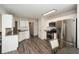 Bright kitchen features stainless steel appliances, white cabinets and wood-look flooring at 581 Victorian Cir, Dallas, GA 30157