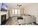 Cozy living room with a fireplace, TV and ample natural light from large windows at 581 Victorian Cir, Dallas, GA 30157