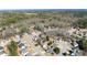 A neighborhood aerial view of residential homes surrounded by lush greenery and mature trees at 602 Kenion Forest Way, Lilburn, GA 30047