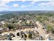 A picturesque aerial view of a suburban community near wooded areas and distant mountain views at 602 Kenion Forest Way, Lilburn, GA 30047