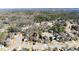 A serene neighborhood aerial view featuring a mix of homes among tall trees and lush landscapes at 602 Kenion Forest Way, Lilburn, GA 30047