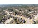 A scenic neighborhood aerial view displaying many homes amidst the canopy of mature trees and winding roads at 602 Kenion Forest Way, Lilburn, GA 30047