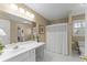 Bathroom featuring dual sinks, ample counter space, and a well-lit vanity area for a refreshing and bright experience at 602 Kenion Forest Way, Lilburn, GA 30047