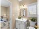 Cozy bathroom with a white vanity, mirror, and bright lighting at 602 Kenion Forest Way, Lilburn, GA 30047