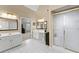 Ensuite bathroom featuring double sinks, vanity area, and glass-enclosed shower with tiled floor at 602 Kenion Forest Way, Lilburn, GA 30047