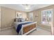 Bedroom featuring neutral walls, a window providing natural light, and a ceiling fan to keep you cool and comfortable at 602 Kenion Forest Way, Lilburn, GA 30047