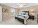 Bedroom featuring a window providing natural light, complemented by a modern bed frame and sleek bedside table at 602 Kenion Forest Way, Lilburn, GA 30047