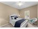 Cozy bedroom featuring a white bed frame, a window, and a ceiling fan at 602 Kenion Forest Way, Lilburn, GA 30047