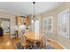 Bright breakfast nook features hardwood floors, a pendant light, and natural light at 602 Kenion Forest Way, Lilburn, GA 30047