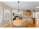 Sunlit breakfast nook with hardwood floors connects to the kitchen and the Gathering room at 602 Kenion Forest Way, Lilburn, GA 30047