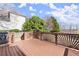 Open wood deck with decorative wood railings overlooks the backyard at 602 Kenion Forest Way, Lilburn, GA 30047