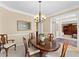 Bright dining room featuring classic decor, wooden table, and charming ambiance at 602 Kenion Forest Way, Lilburn, GA 30047