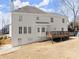 Exterior of home showcasing the deck, white siding, and lush backyard at 602 Kenion Forest Way, Lilburn, GA 30047