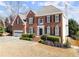 Brick two-story home featuring a two-car garage and manicured landscaping at 602 Kenion Forest Way, Lilburn, GA 30047