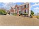 Brick two-story home featuring a two-car garage and manicured landscaping at 602 Kenion Forest Way, Lilburn, GA 30047