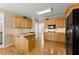 Bright kitchen with granite counters, wood cabinets, and hardwood floors at 602 Kenion Forest Way, Lilburn, GA 30047