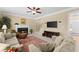 Spacious living room features a fireplace, flat screen tv, and comfortable seating at 602 Kenion Forest Way, Lilburn, GA 30047