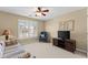 Cozy living room with neutral walls, a large window providing natural light and comfortable seating for relaxation at 602 Kenion Forest Way, Lilburn, GA 30047