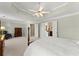 Main bedroom showcases the tray ceiling with fan, neutral color palette, and ensuite access at 602 Kenion Forest Way, Lilburn, GA 30047