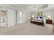 A view of the main bedroom with access to the ensuite bathroom and laundry room at 602 Kenion Forest Way, Lilburn, GA 30047