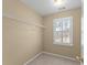 A bedroom walk-in closet with a shelf and a window with shutter at 602 Kenion Forest Way, Lilburn, GA 30047