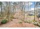 Picturesque backyard featuring mature trees and lush greenery, providing a private and serene outdoor space at 608 Ridge Crossing Dr, Woodstock, GA 30189