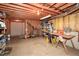 Large unfinished basement featuring exposed wood ceiling, storage shelves and workbench perfect for a workshop at 608 Ridge Crossing Dr, Woodstock, GA 30189