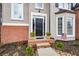 Welcoming front entrance with a black door, brick accents, and manicured landscaping at 608 Ridge Crossing Dr, Woodstock, GA 30189