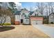 Charming two-story home with a well-manicured front yard and attached two-car garage at 608 Ridge Crossing Dr, Woodstock, GA 30189