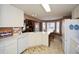 Bright kitchen featuring white cabinets, a dishwasher, and an adjacent breakfast nook at 608 Ridge Crossing Dr, Woodstock, GA 30189