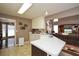 Open-concept kitchen with a peninsula, neutral tile floors, and warm-toned walls at 608 Ridge Crossing Dr, Woodstock, GA 30189